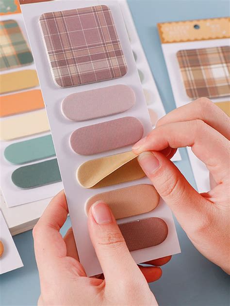 a person holding a palette in front of some color swatches on a blue surface