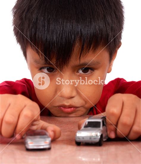 Boy Playing With Toy Cars On A Table Royalty-Free Stock Image - Storyblocks