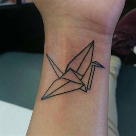 Origami crane tattoo on the wrist.