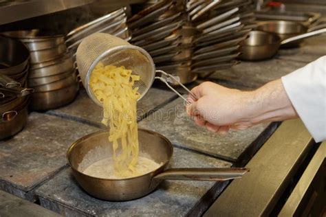 Chef is cooking pasta stock image. Image of catering - 69590649