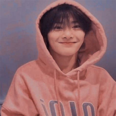 a person wearing a pink hoodie and smiling
