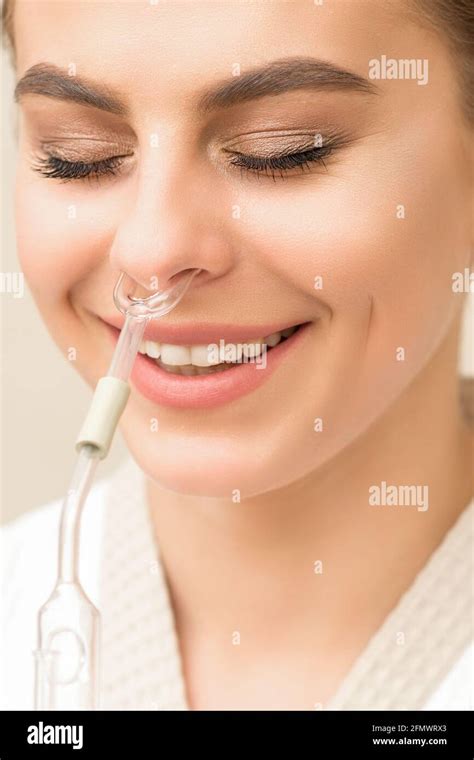 Beautiful happy young caucasian woman receiving nasal inhaler with essential oil smiling in a ...