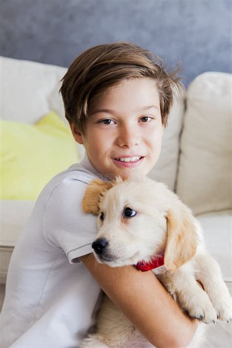 Cute Teen Boy with Baby Retriever Dog in Room Stock Photo - Image of childhood, person: 101572852