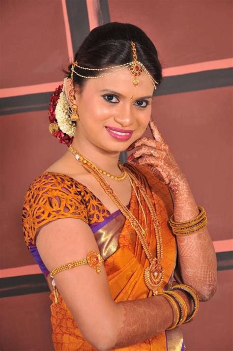 Traditional Southern Indian bride wearing bridal hair, saree and jewellery. Muhurat look. Makeup ...