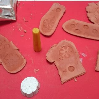 The 3D printed stamping tools and sheets of clay with stamp imprints of ...