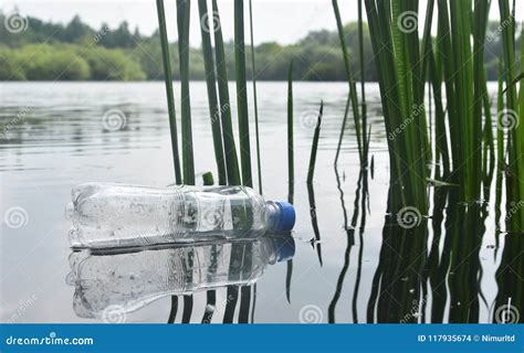 Discarded Plastic Bottle Floating in a Lake Stock Photo - Image of litter, environmental: 117935674