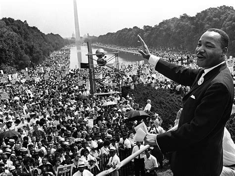 Martin Luther King Jr. waves to the crowd during the March on Washington from the steps of The ...