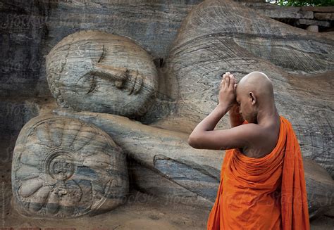 "Buddhist Monk Praying At The Reclining Buddha. Polonnaruwa. Sri Lanka." by Stocksy Contributor ...