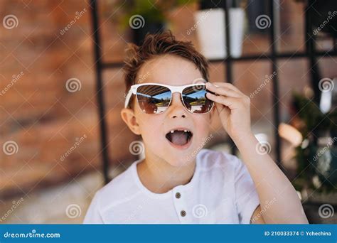 Cute Cauasian Boy In White Tee Shirt And Sunglasses Posing For Camera And Showing His Lost Tooth ...