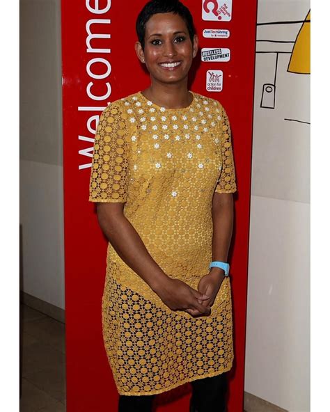 a woman standing in front of a red sign