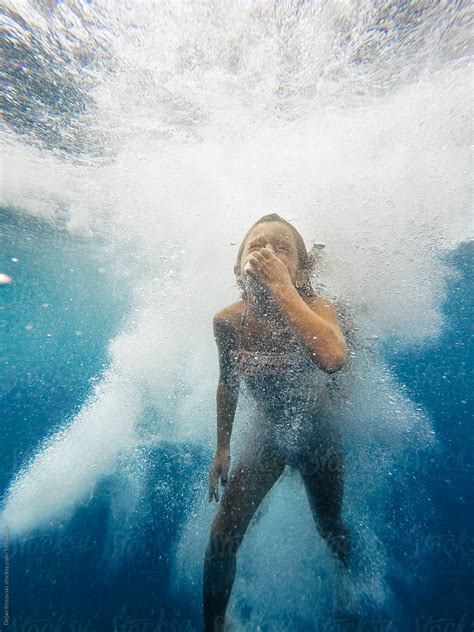 Little girl hold her breath underwater. by Dejan Ristovski - Stocksy United