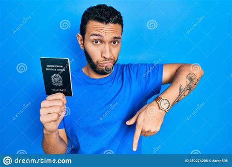 Hispanic Man with Beard Holding Italy Passport Pointing Down Looking ...