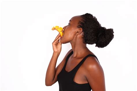 Healthy woman eating sliced mango