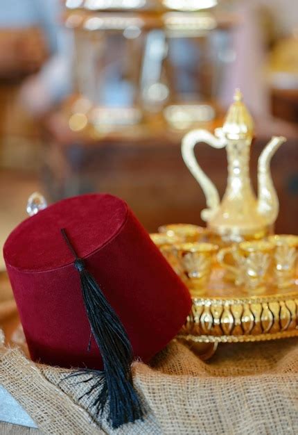 Premium Photo | Red fez tarboosh hat with black tassel with arabic ...