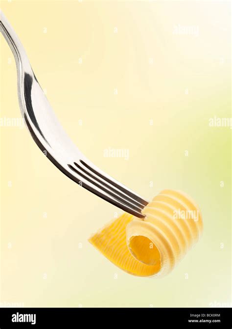 Butter curl on a fork Stock Photo - Alamy