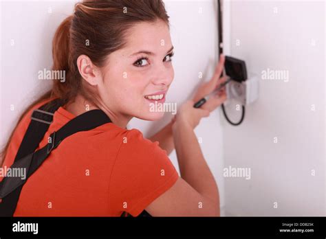 Female electrician wiring a wall socket Stock Photo - Alamy