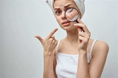 Premium Photo | Woman with a magnifying glass in hand skin problems closeup