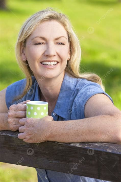 Beautiful Happy Middle Aged Woman In Her Thirties Or Forties Smiling And Leaning On Fence In ...