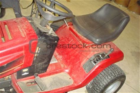 Image 530036: Old Red Riding Lawn Mower from Crestock Stock Photos