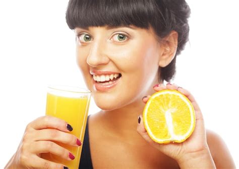 Premium Photo | Brunette woman holding orange juice