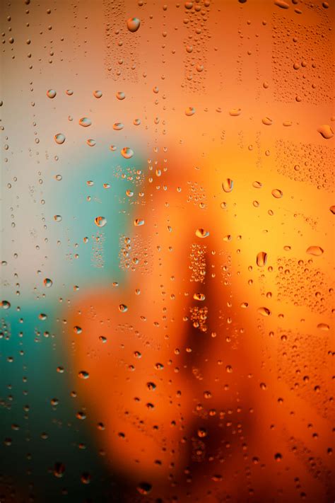 Download Raindrops On Orange And Teal Window Wallpaper | Wallpapers.com