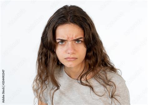 Human expressions and emotions. Portrait of young furious girl with angry face isolated on white ...