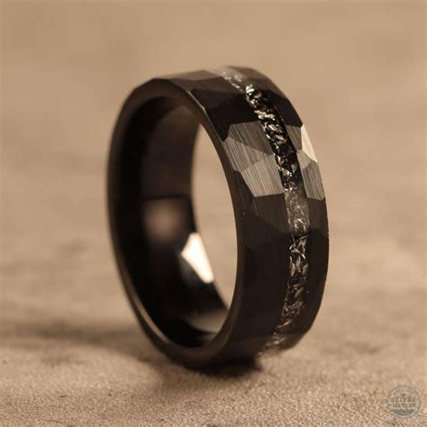 a black ring with an intricate design on the outside and inside ...