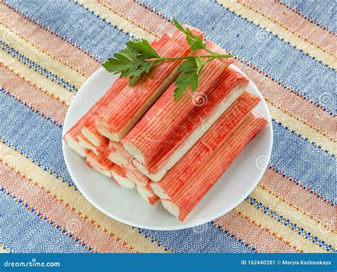 Surimi Crab Sticks and Parsley on a White Saucer Over a Striped Table Mat. Seafood and ...