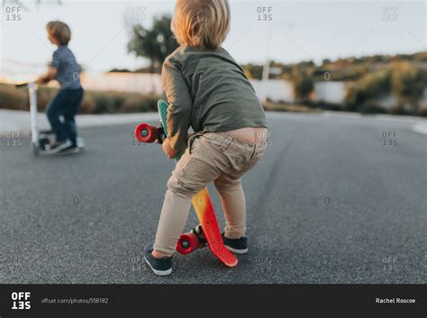 Toddler boy with pants falling down stock photo - OFFSET