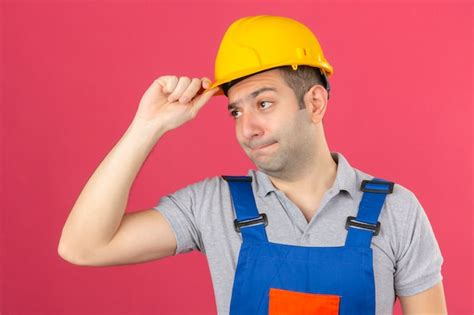 Free Photo | Construction worker in uniform and safety helmet with unhappy face touching his ...