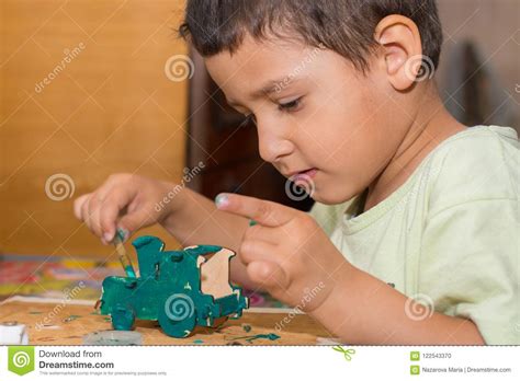 Boy is Painting a Wooden Toy Car Stock Photo - Image of pastime, childhood: 122543370