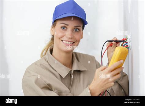 female electrician testing a wall socket Stock Photo - Alamy
