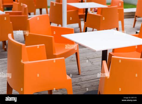 Modern furniture outdoor cafe terrace with orange chairs Stock Photo - Alamy