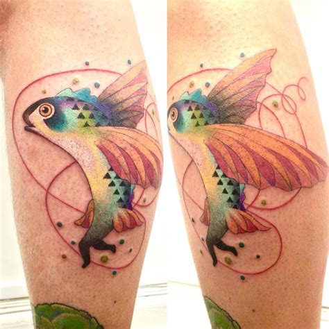 Illustrative flying fish tattoo on the left calf.