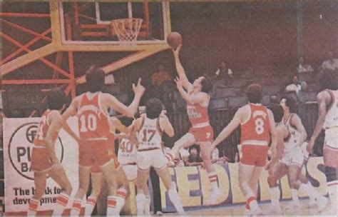 Robert Jaworski of the Toyota Silver Coronas takes a layup with their other Toyota players ...