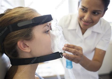 Adjusting ventilator mask - Stock Image - C019/3849 - Science Photo Library