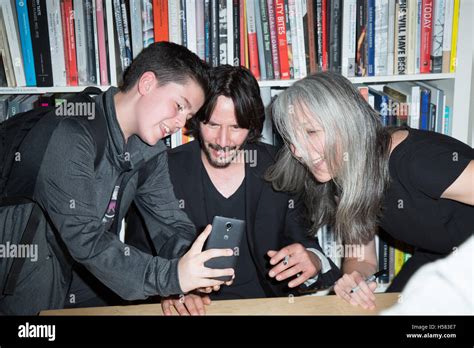 A fan, Keanu Reeves and Alexandra Grant attend Alexandra Grant and Keanu Reeves book “Shadows ...