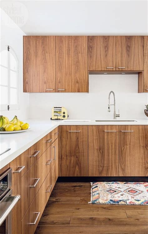 Walnut kitchen cabinetry with white counter and backsplash // mid ...