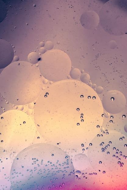 Premium Photo | Macro shot of water oil emulsion over colored background