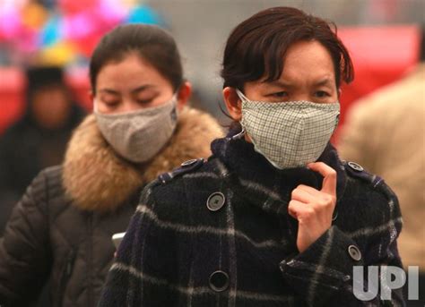 Photo: Chinese wear masks for protection against hazardous pollution in Beijing - PEK2014022301 ...