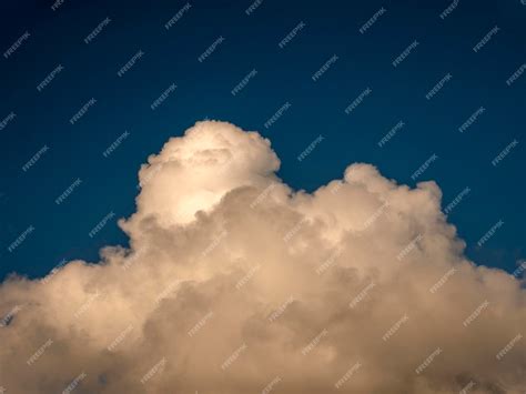 Premium Photo | Fluffy clouds over sunset sky fluffy cumulus cloud shape photo gloomy cloudscape ...