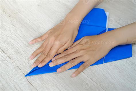 Woman's hand folding origami paper 8531889 Stock Photo at Vecteezy