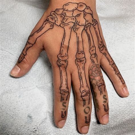 Skeleton hand tattoo - bones | Skeleton hand tattoo, Skull hand tattoo, Skeleton tattoos