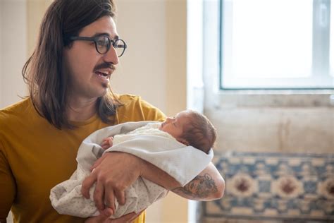 A Father Carrying a Baby · Free Stock Photo