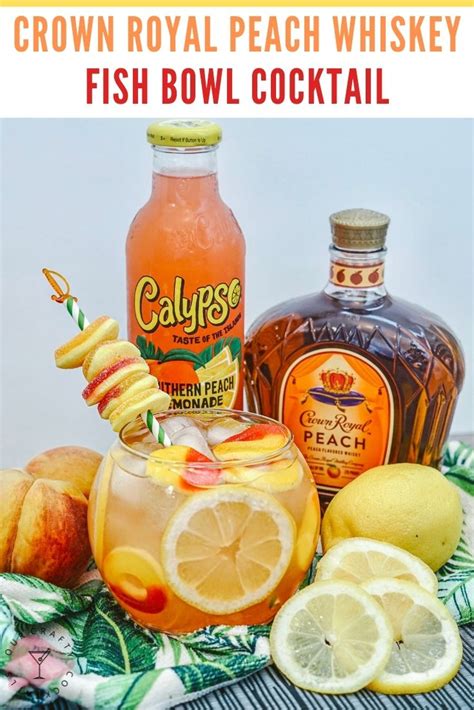 the crown royal peach whiskey fish bowl cocktail is garnished with lemons and orange slices