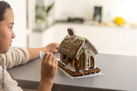 Kids baking Christmas gingerbread house. Children celebrating winter holiday at home. Decorated ...