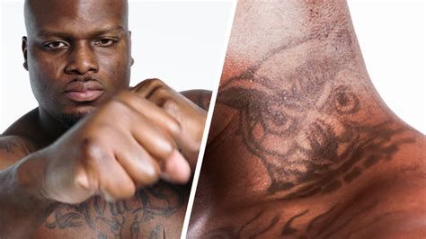 Watch UFC Fighter Derrick Lewis Breaks Down His Tattoos | Tattoo Tour | GQ