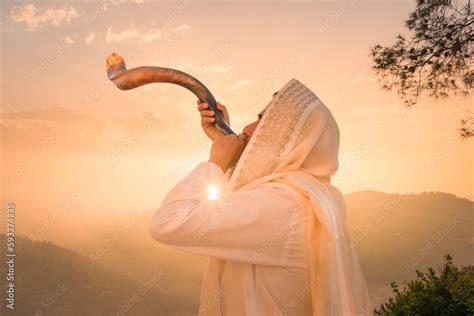 A Jewish man blowing the Shofar (ram's horn), which is used to blow sounds on Rosh HaShana (the ...