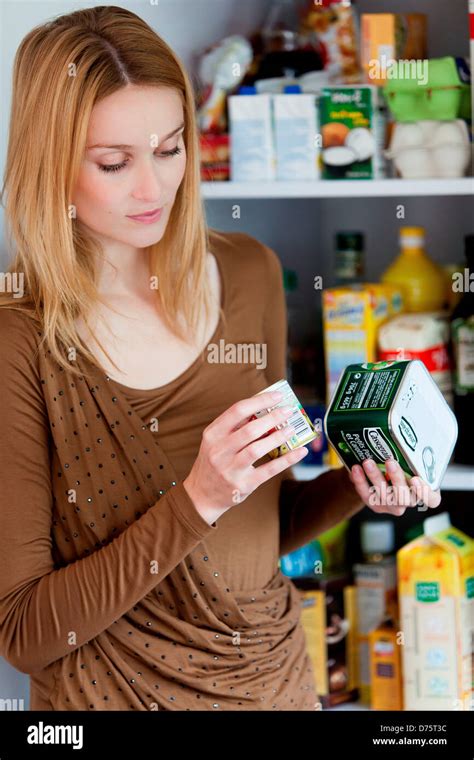 Woman checking the composition and nutrition facts Stock Photo - Alamy
