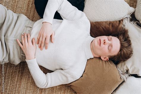 Stylish young man sleeping on floor Stock Photo | Adobe Stock